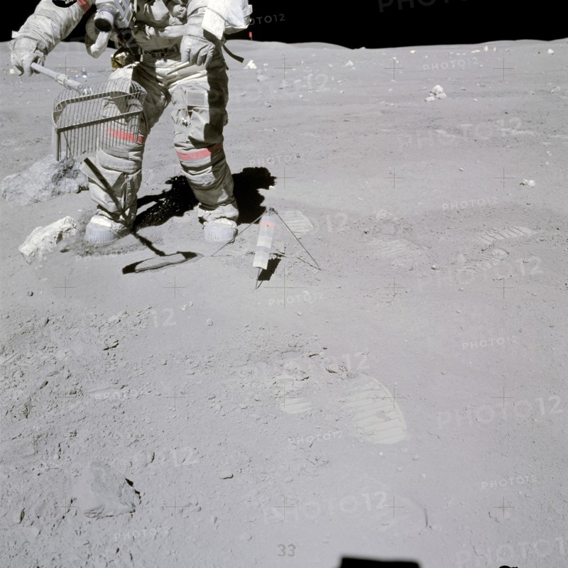 Astronaut John W. Young collects samples