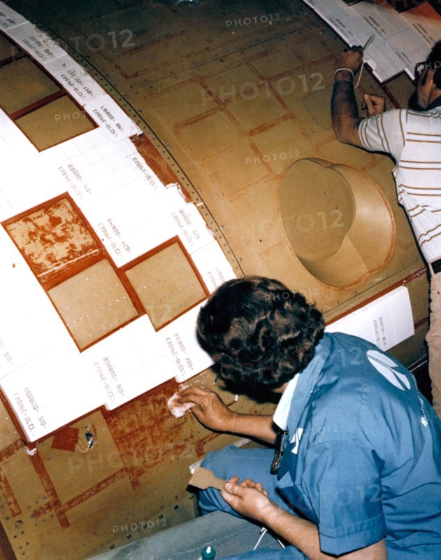 Rockwell International technicians mount ceramic tiles