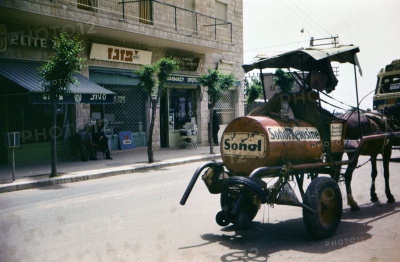 A horse drawn cart pulls a tank of kerosene