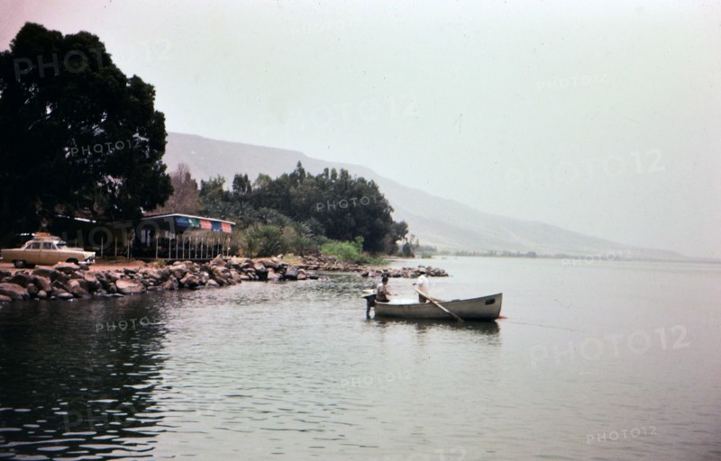Two men rowing a boat in Lake Gailee in Israel