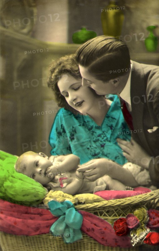 Couple admiring an Infant.