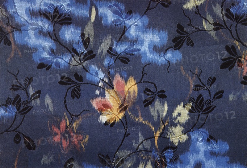 Silk weave of colored and small black flowers.