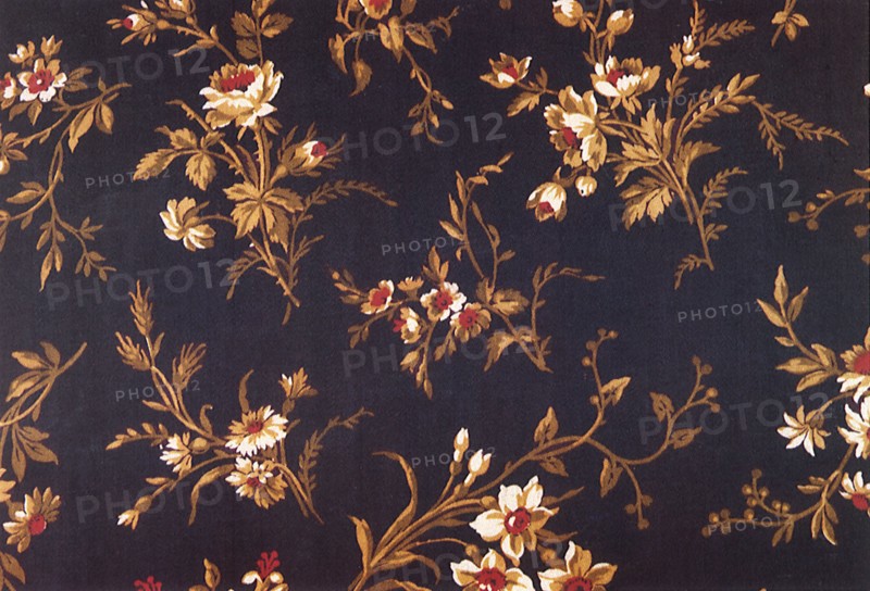 Floral pattern of light brown flowers with red centers.