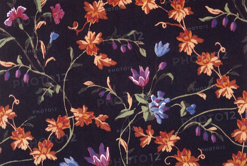 Orange and purple flower repeat pattern on dark background.