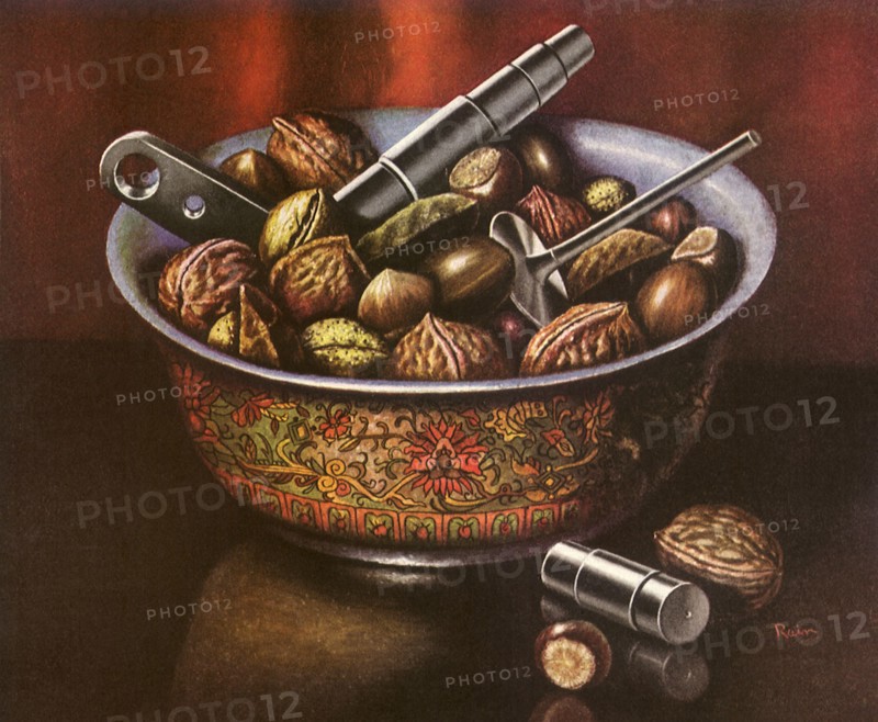 A bowl of walnuts and assorted nuts with nutcracker tools.