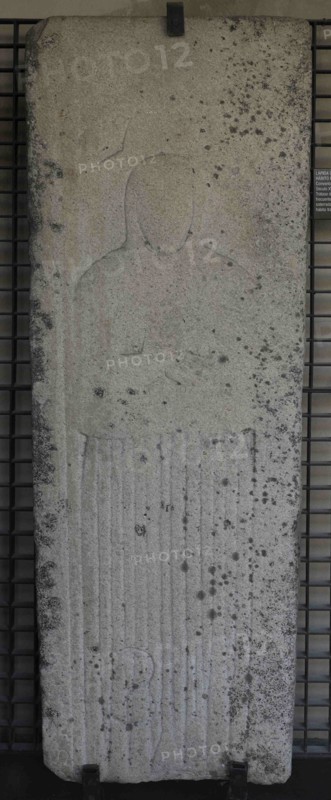 Tombstone with bas-relief depicting a woman wearing the Franciscan habit