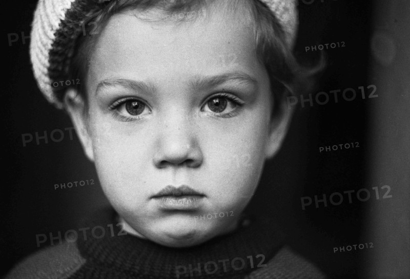 Liittle boy in a sweater and beret.
