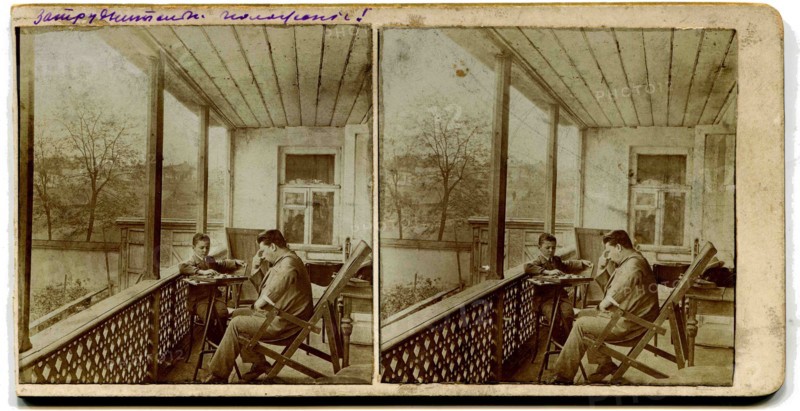 A stereo, a man with a boy playing checkers on the porch at home.