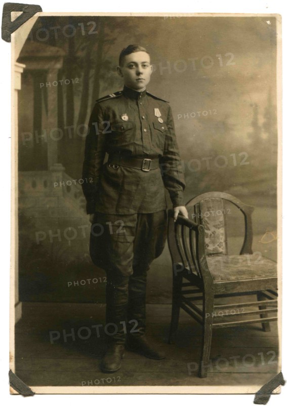 Soviet Army sergeant with a medal For the Victory in Great Patriotic War and the sign Guard on his chest.