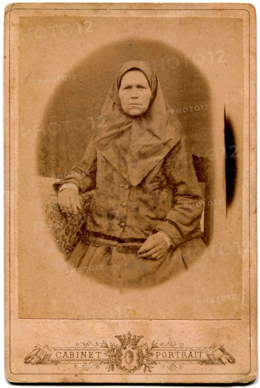 An elderly woman in a headscarf.