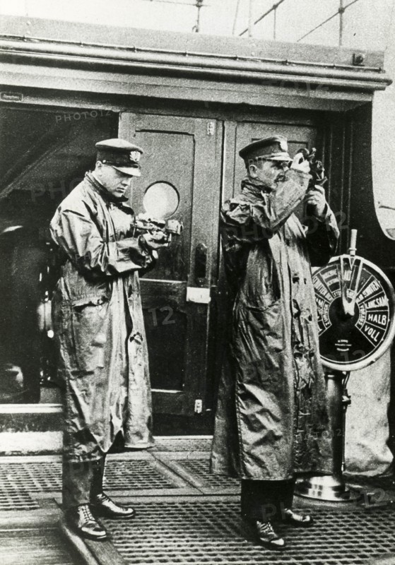 Command Bridge Of A British Ship, Two Officers Are Studying The Route.