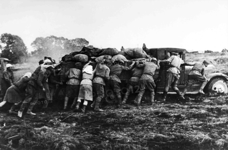 Farmers Help Soldiers Pushing A Truck Loaded In The Russian Steppe.