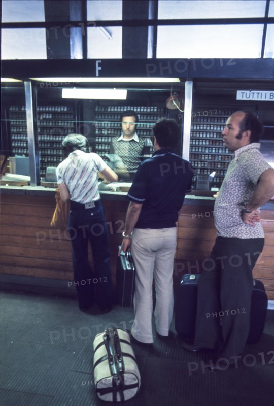 Central station of milan, passengers at ticket office , 70's