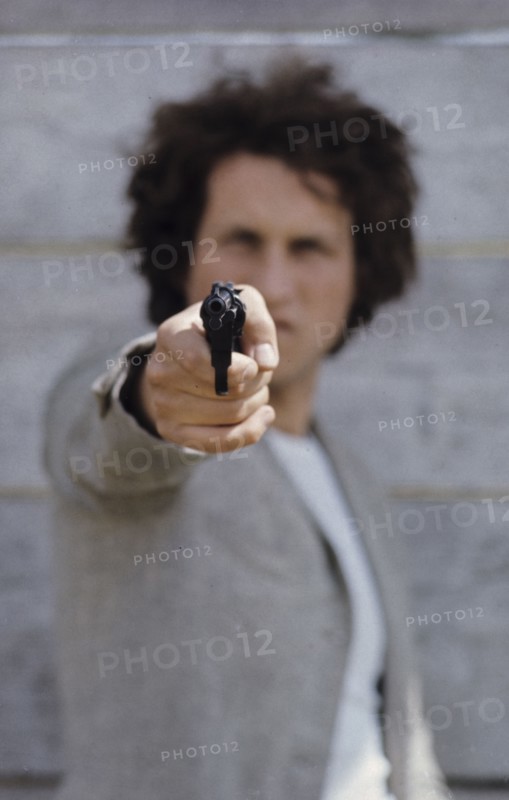 Man with gun, 70's