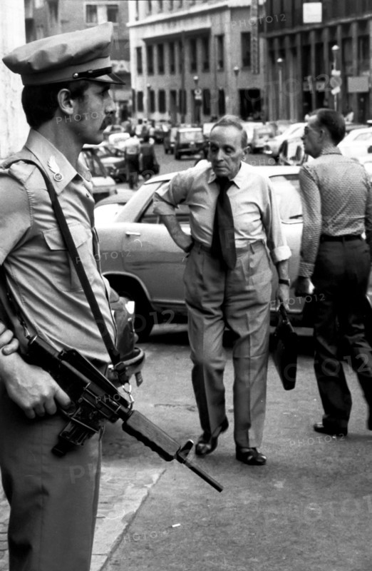Policeman with a handgun in a street of naples, italy, 80's