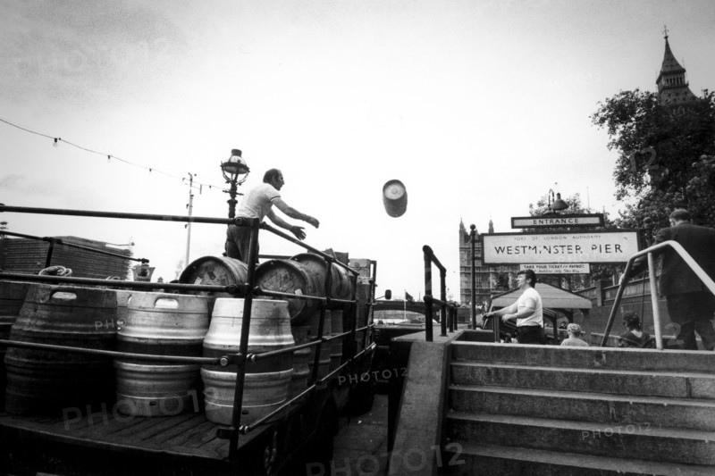 Workers loading barrells on truck at westminster pier, london, uk, 70's