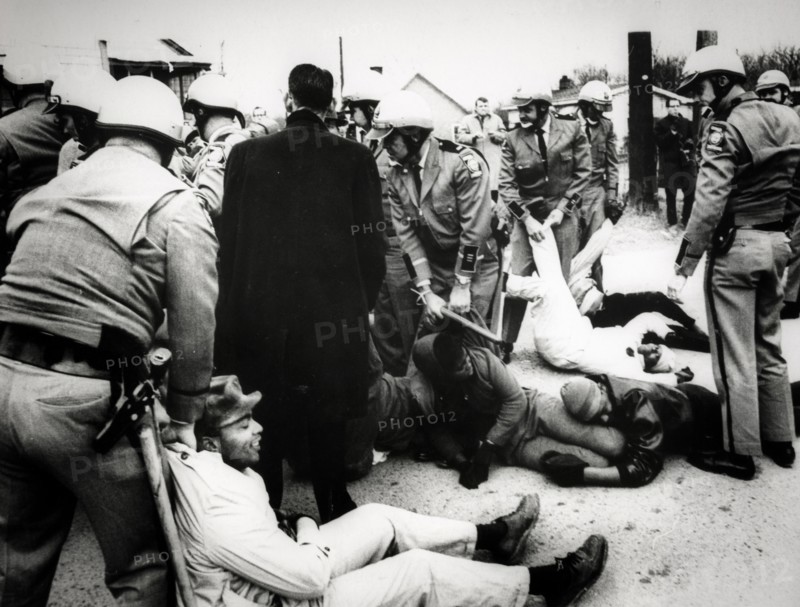 Troopers drag demonstrators to prison buses after about 60 persons laid down in the street to block a school bus from going to the all-negro social circle training school, georgia, 1968