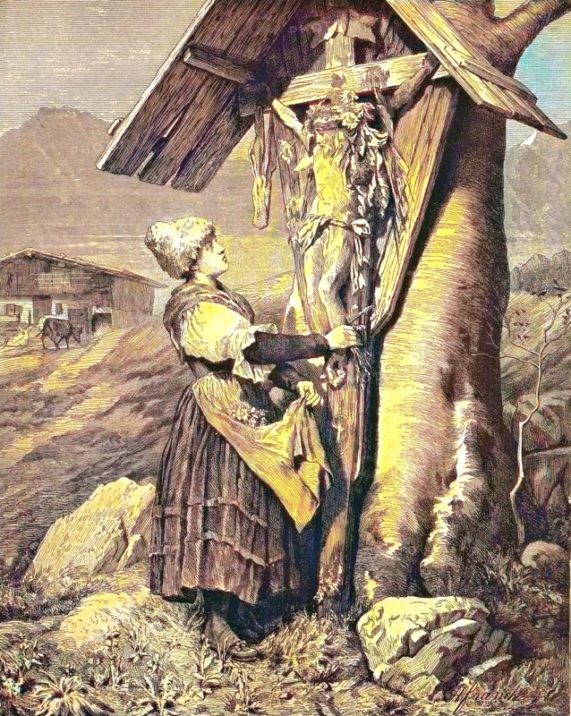 Woman in front of a field cross in the Alps