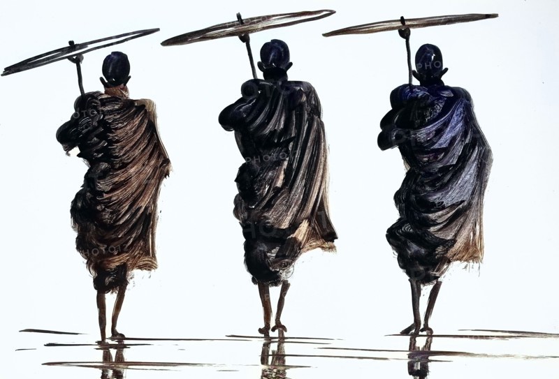 three monks with parasol