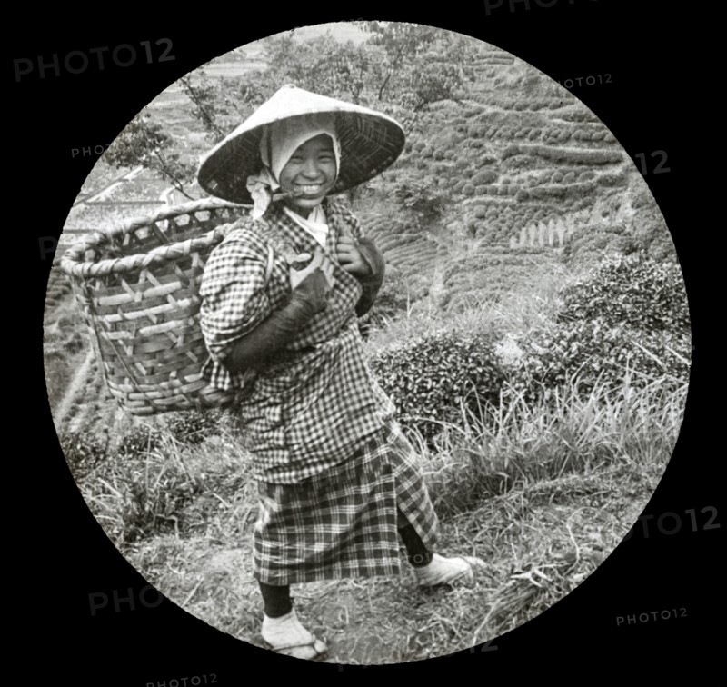 A native girl with basket on her back.