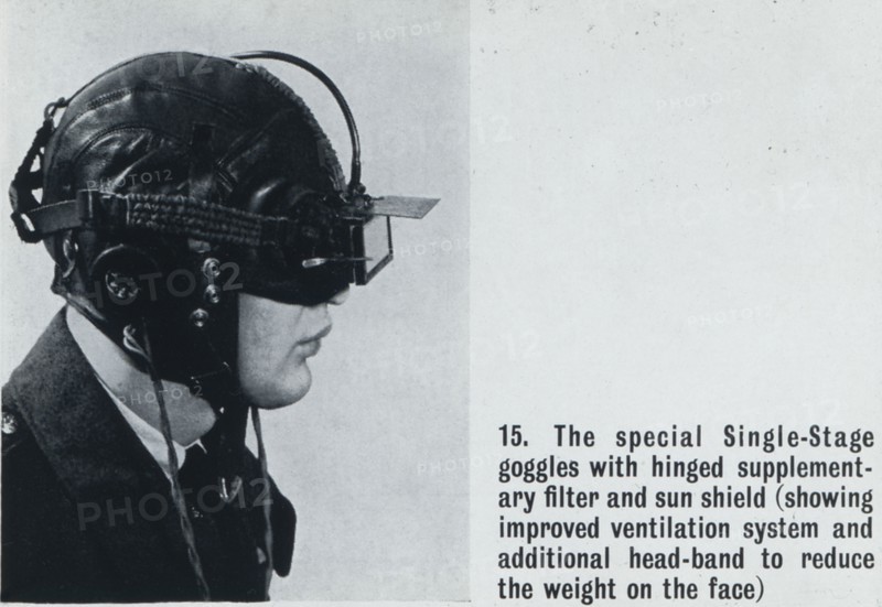 A pilot with night/day goggles and head set.