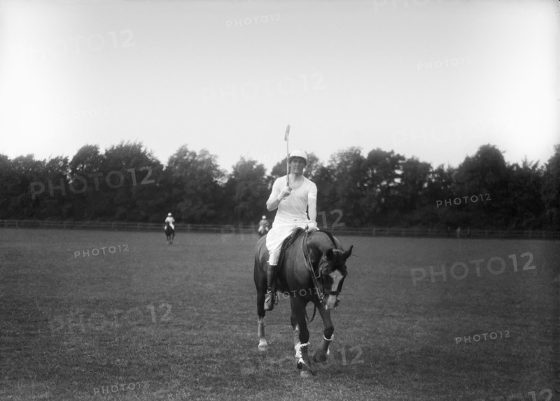 Man on horse at the end of a game of polo.