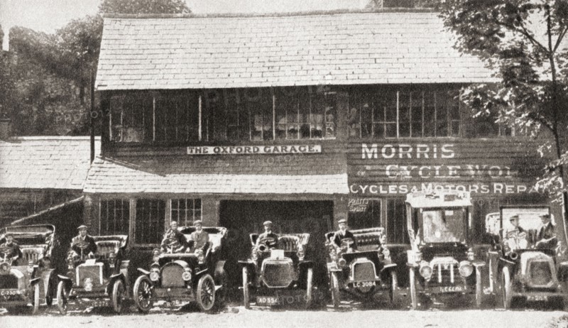A row of early Morris cars parked outside The Oxford Garage.