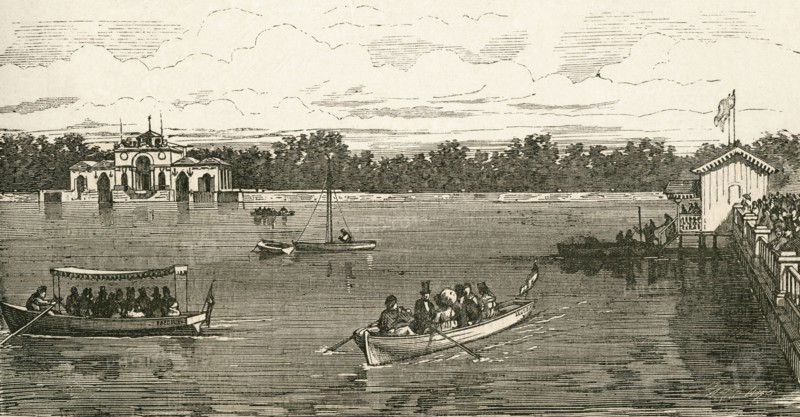 People boating on the lake in the Retiro Park.