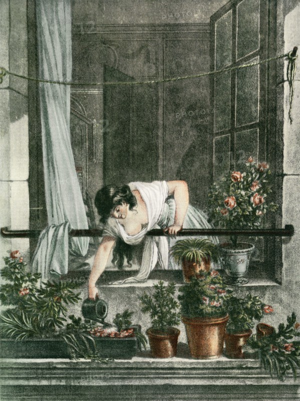 Young woman watering plants on her balcony.