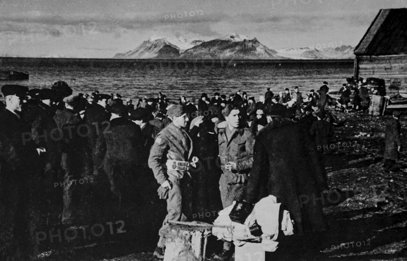 Norwegians waiting to be taken aboard British vessels in the late evening in Spitzbergen.
