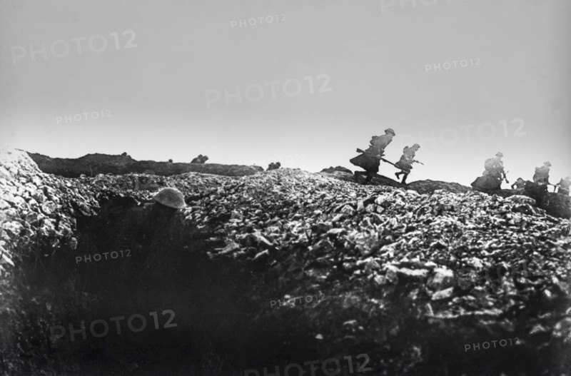 World war 1 troops leaving the trenches and charging with guns.