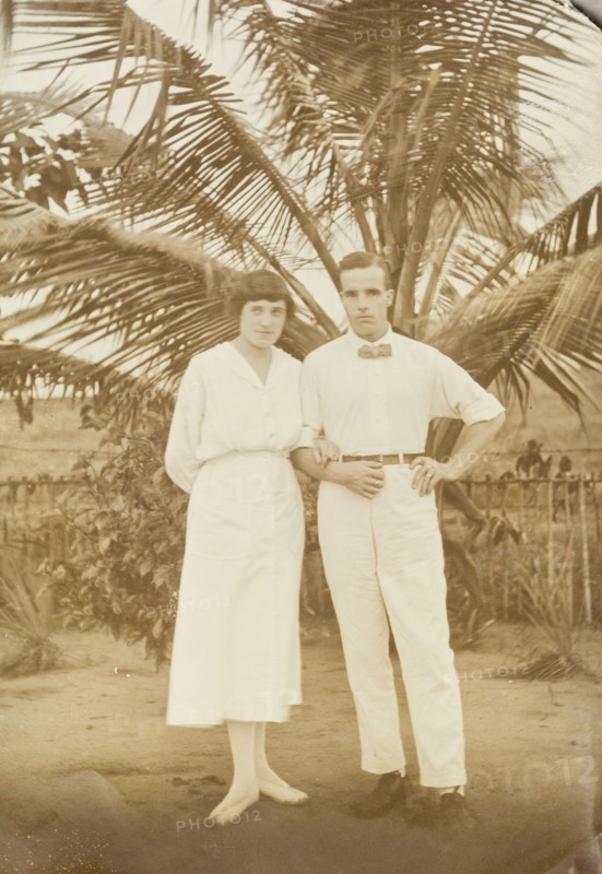Mr and Mrs Tamlin in the shade of a palm tree