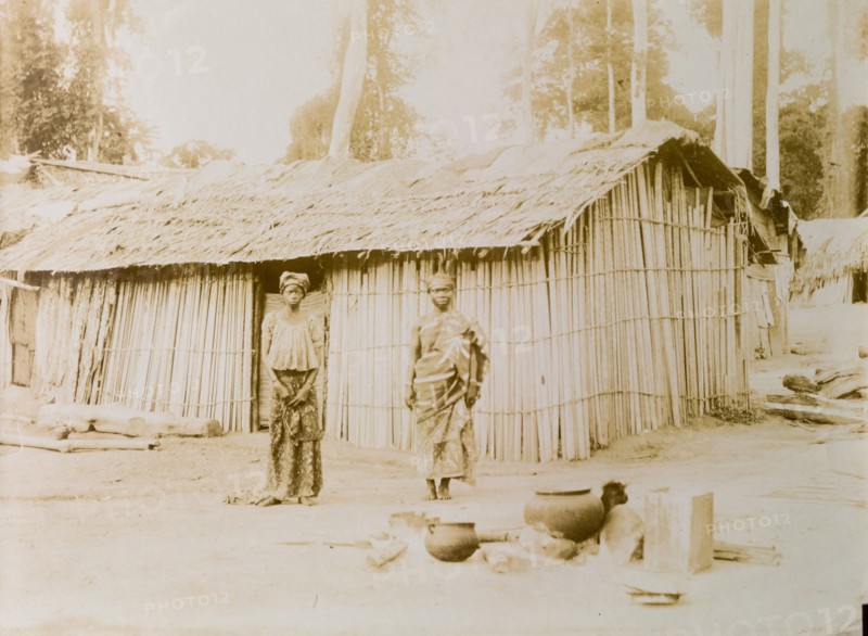 Ghanaian couple outside their hut