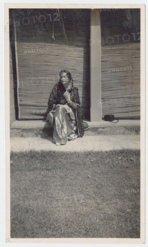 Seated woman in sari during railway outing