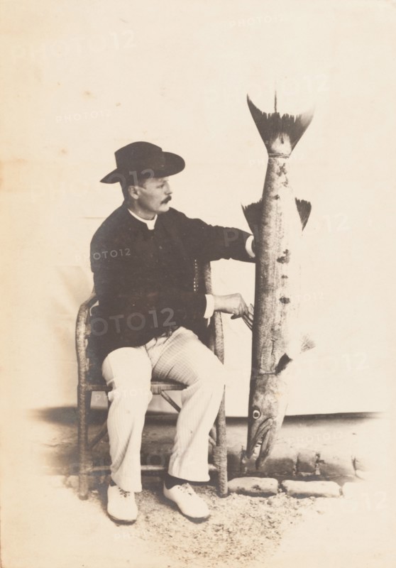 European man posing with a fish