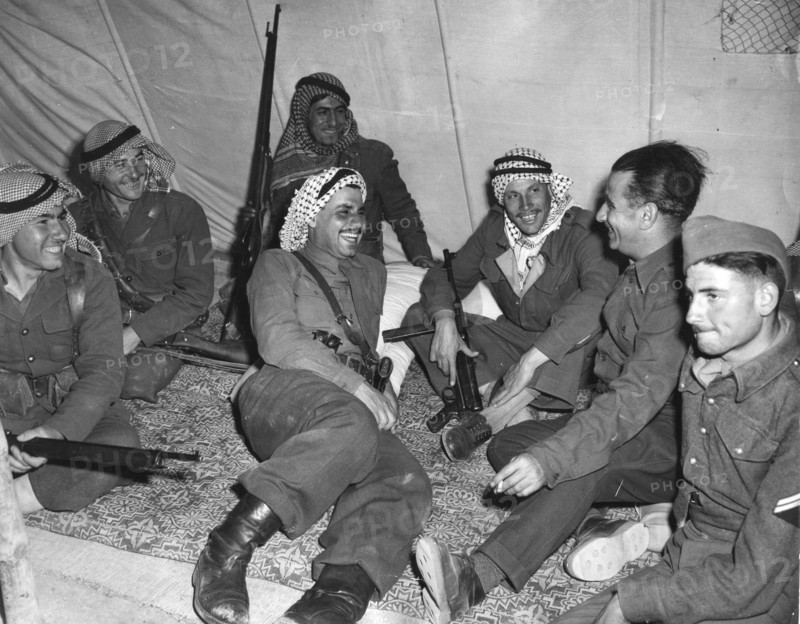 Arab soldiers relax in their tent with the arms nearby, near Nablus, Palestine.