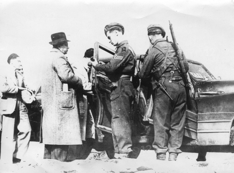 The British military stops cars on the roads in Palestine, to search them and check the identity of the passengers.