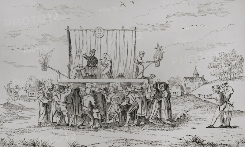 Europe. A juggler's stage set in a village. On stage a juggler and a medicine seller talking to the crowd. Engraving after a 15th-century manuscript. Sciences & Lettres au Moyen Age et a l'epoque de la Renaissance. Paris, 1877.