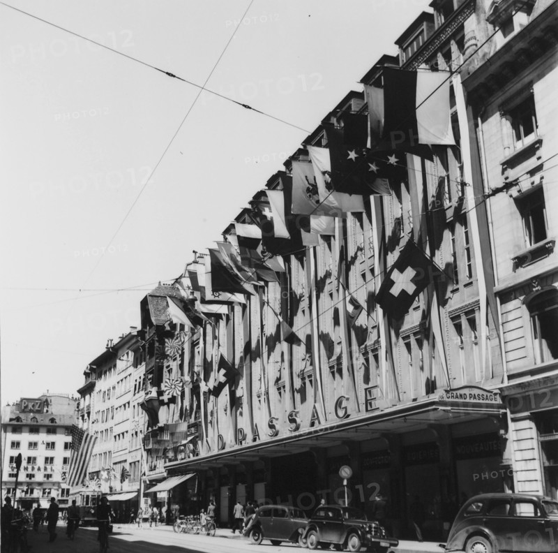 Frontage decorated with flags;  end of second world war; 1945.