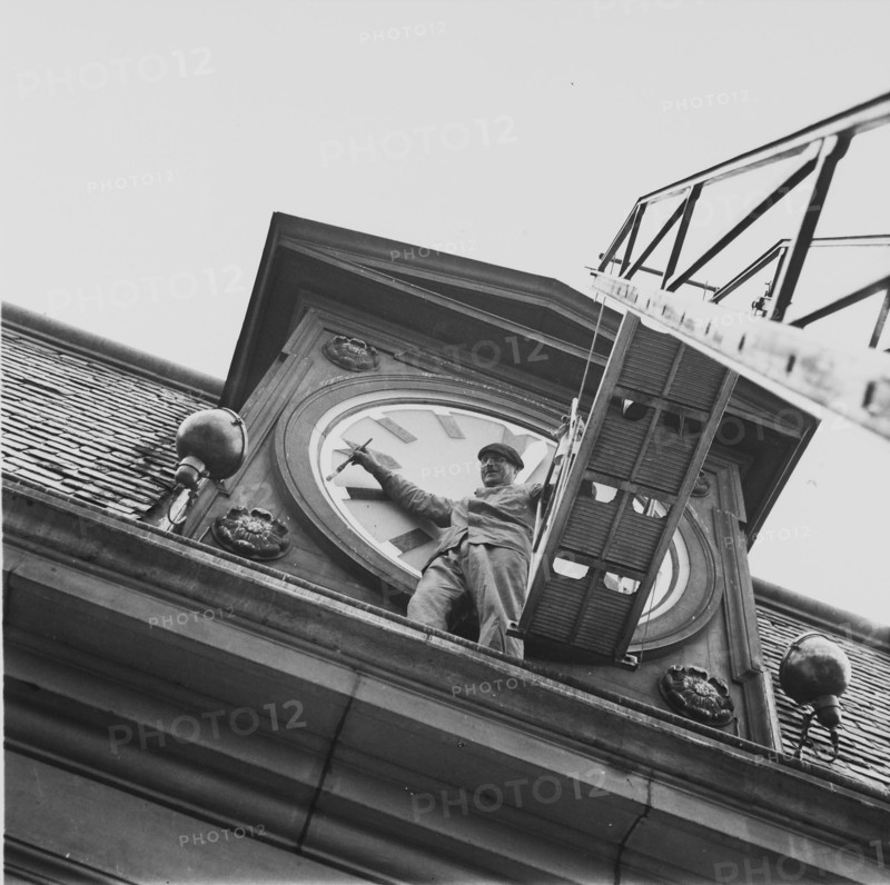 Blackout: man painting numerals of church clock with luminous paint, ca. 1943.