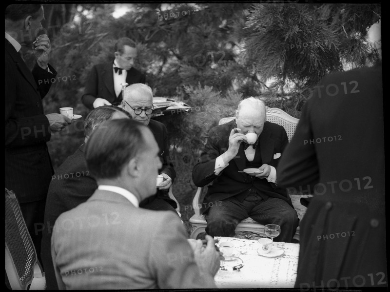 Winston Churchill with Swiss public figures at afternoon coffee 1946 .