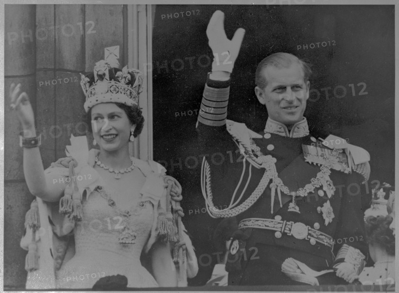 Waving to the crowd from the Buckingham Palace balcony