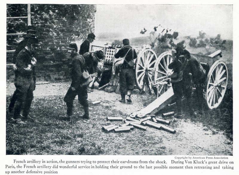 This photo taken in early World War I has the caption: French artillery in action, the gunners trying to protect their ear-drums from the shock. During Von Kluck's great drive on Paris, the french artillery did wonderful servie in holding their ground to the last possibe moment then retreating and taking up another defensive position.