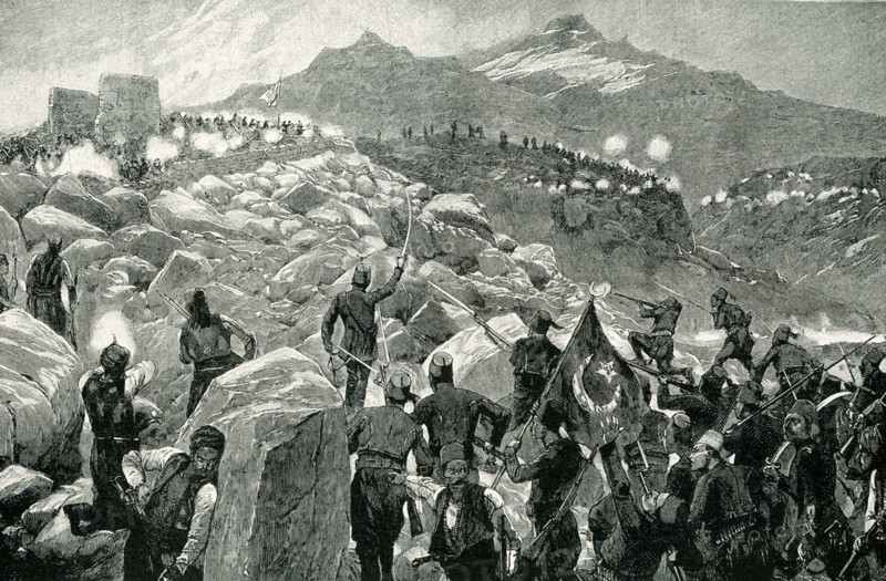 The early 1900s caption reads: Turkish Troops Attack Cretan Insurgents. During the Cretan Insurrection of 1896, the Christians of Crete were obliged to retire to the mountains to escape the massacre by the Turkish troops. When, however, they were pursued into their wild retreats, they defeated the troops repeatedly. A glance at the picture will show you how impossible it was for the Turks to drive resolute men from these picturesque fortresses, amid rock and cliff.