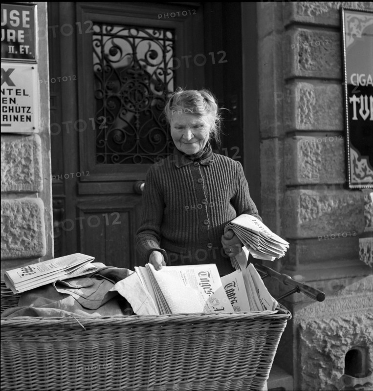 Newspaper home delivery by Mrs. Straub, on duty for 50 years; Zurich ca,. 1950.
