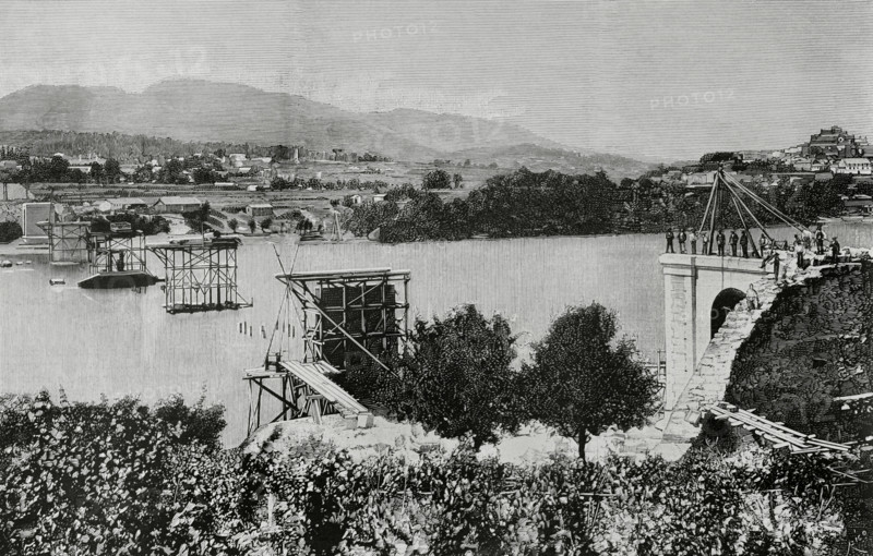 History of Spain. Galicia. Province of Pontevedra. Tui International Bridge over the Mino river. It was designed by the engineer Pelayo Mancebo y Agreda (1845-1912). Construction work began in 1884, and it was officially opened on 25 March 1886. It provided a connection between the towns of Tui (Spain) and Valenca do Mino (Portugal). State of the masonry works at the start of the foundation of the pillars. Engraving by Bernardo Rico. La Ilustracion Espanola y Americana (The Spanish and American Illustration), March 8, 1884.
