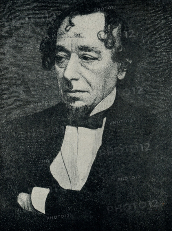 This 1899 illustration shows Lord Beaconsfield (Benjamin Disraeli).  Earl of Beaconsfield, of Hughenden in the County of Buckingham, was a title in the Peerage of the United Kingdom. It was created in 1876 for Prime Minister Benjamin Disraeli, a favourite of Queen Victoria. Victoria favoured Disraeli's Tory policies over those of his Liberal rival, William Ewart Gladstone.