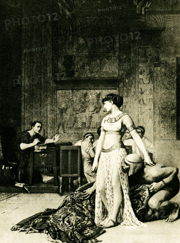 The caption on this 1903 image reads: “Cleopatra before Julius Caesar from painting by Gerome.” It appeared in the book History of Egypt by French Egyptologist Gaston Maspero. Aware that Caesar's diplomatic intervention could help her regain the throne. The year was about 48 B.C. From her brother Ptolemy XIII, Cleopatra hatched a scheme to sneak herself into the palace at Alexandria where Julius Caesar was at the time preparing for a conference to bring the warring siblings to an agreement. She wanted an audience with Caesar. She persuaded her servant Apollodoros to wrap her in a carpet (or, according to some sources, a sack used for storing bedclothes), which he then presented to the 52-year old Roman. Jean-Léon Gérôme (1824 –1904) was a French painter and sculptor in the style now known as academicism.