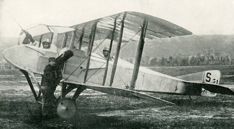 This photo dates to the early 1920s. The caption reads: The Last Word in Fighting Airplanes. This new type of Spad machine shows the propeller mounted between the observer and the pilot, thus giving the observer a clear range in combat instead of the old way of shooting through the propeller.