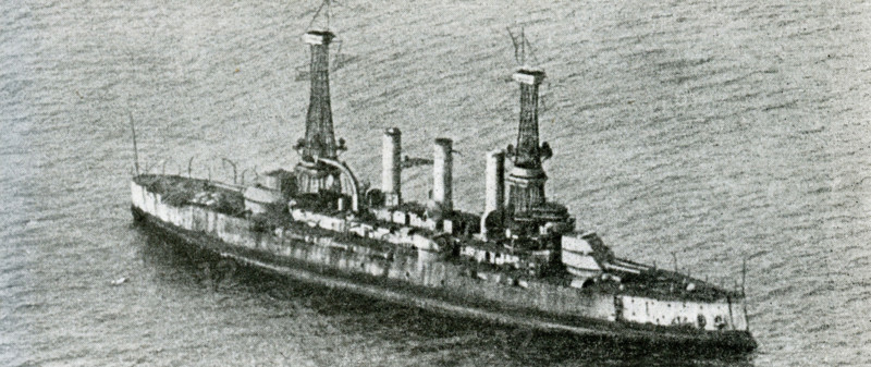 This photo dates to September 5, 1923. The caption reads: What a Bomber from the air can do to a battleship: The doomed battleship Virginia - Seven Minutes Before Noon. This was just before an 1100-pound bomb exploded alongside. She sunk within 20 minutes. In 1922, the U.S. War Department classified the Virginia as a target ship for bombing tests, along with her sister ship the USS New Jersey. The New Jersey was bombed first and sunk and then the Virginia.